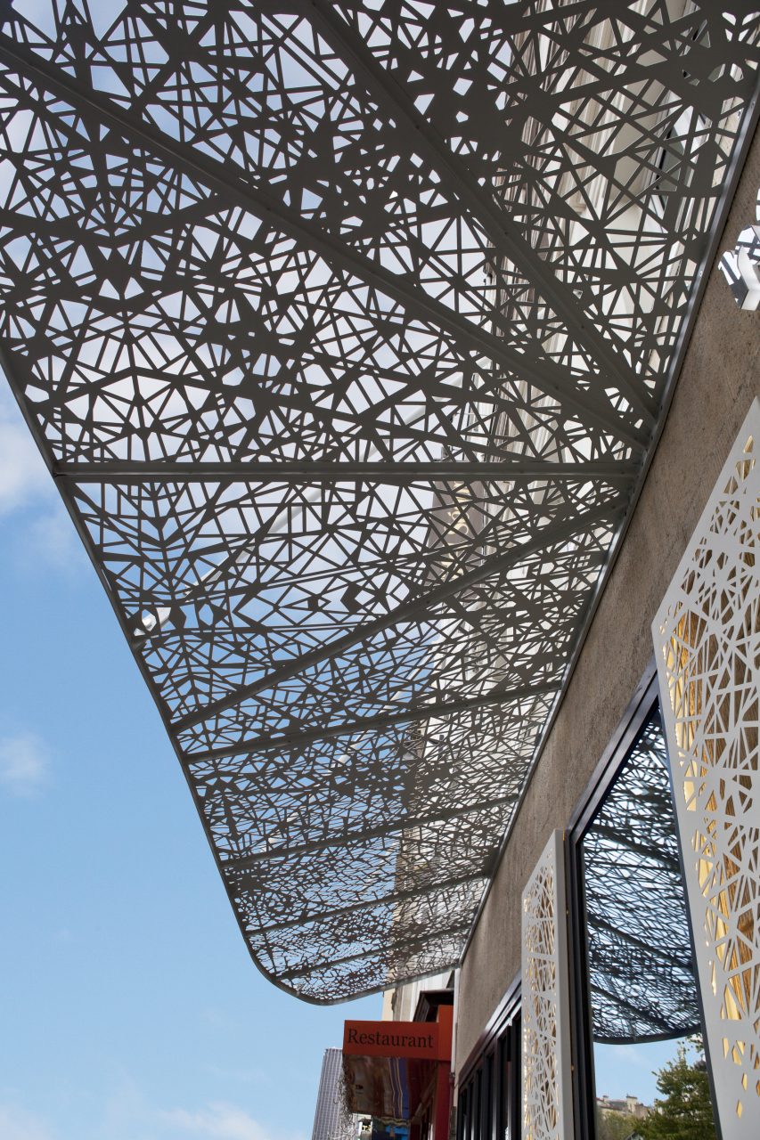 Pergola métallique blanche située au-dessus d'un bâtiment