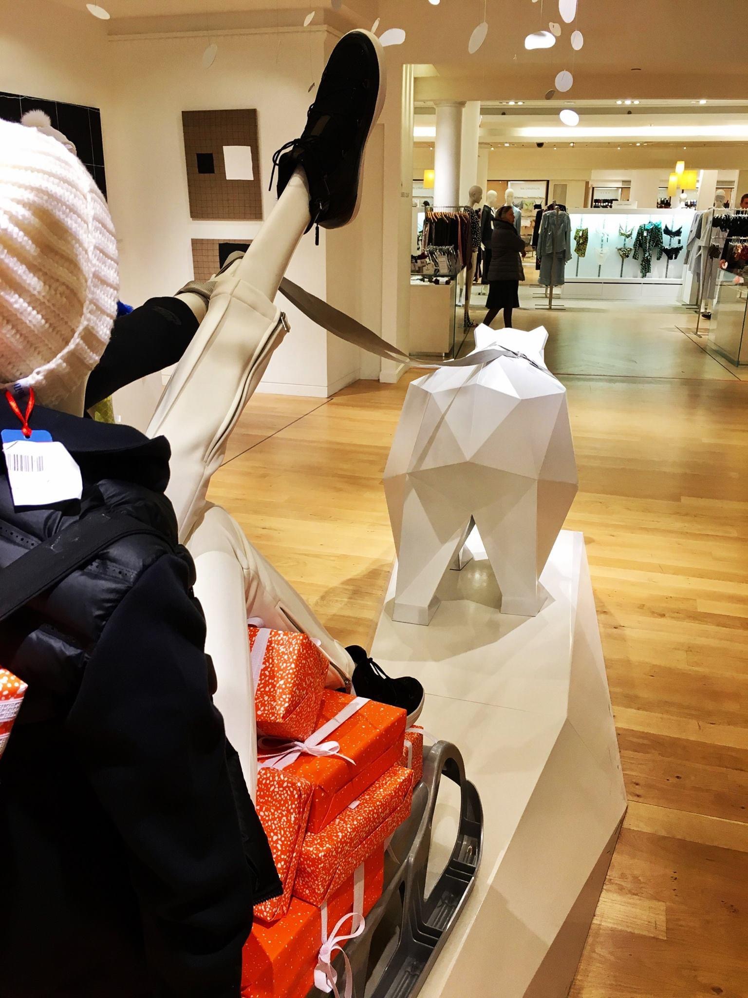 Sculpture métallique blanche représentant un ours polaire située dans un magasin de vêtements